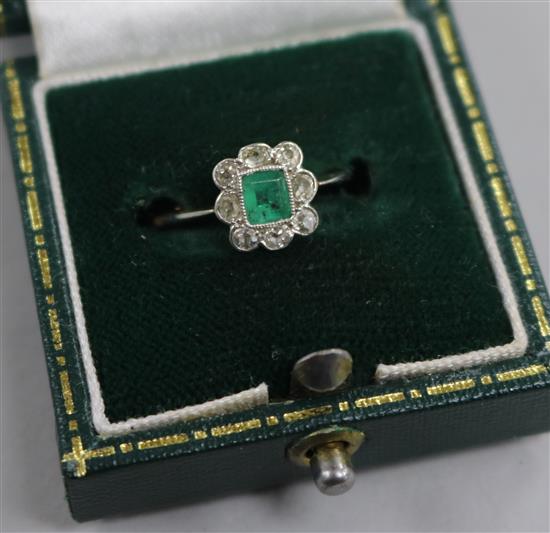 An 18ct gold diamond and emerald cluster ring, size L